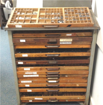 A cabinet full of typecases, with one on top
